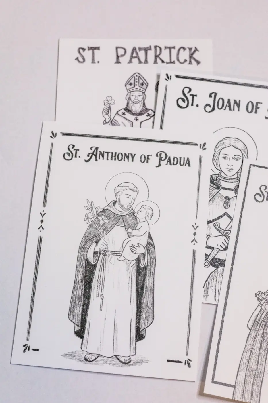Hand-drawn pencil prayer cards for St. Patrick, St. Joan of Arc, and St. Anthony of Padua