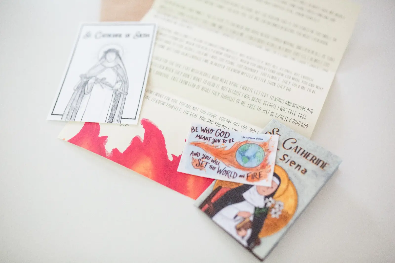Close-up of a Letters from Heaven saint letter, prayer card, and zine