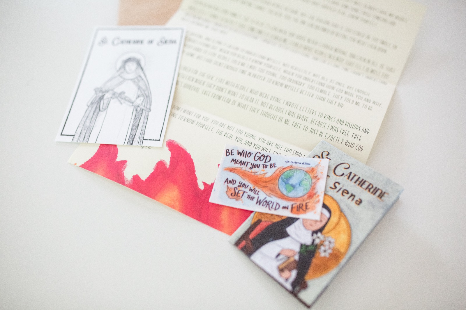 Close-up of a Letters from Heaven saint letter, prayer card, and zine