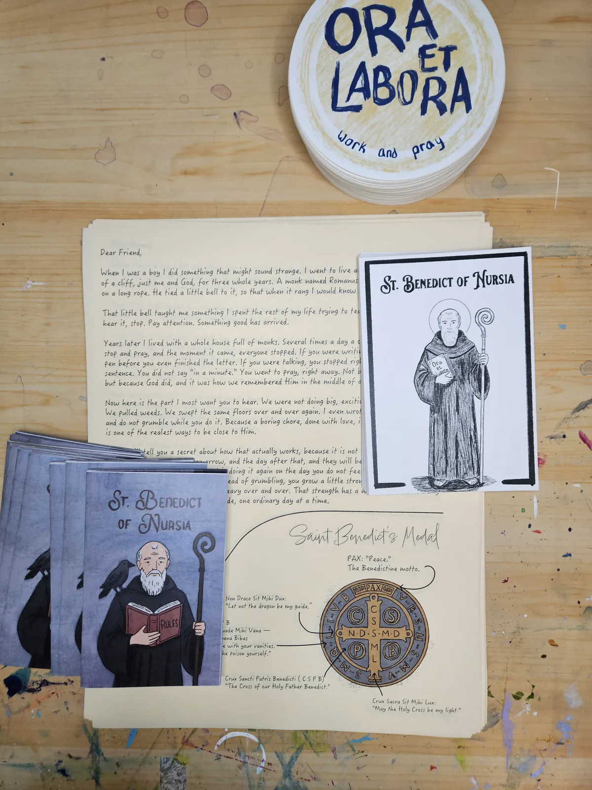 Everything in the July envelope: St. Benedict's hand-drawn letter, prayer card, sticker, and zine